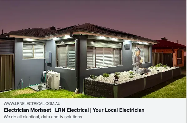 Modern house with outdoor lighting display at night.