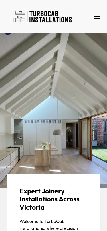 Modern kitchen with vaulted ceiling, natural light.