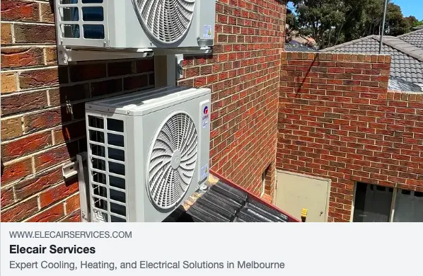 Air conditioning units installed on a brick wall.