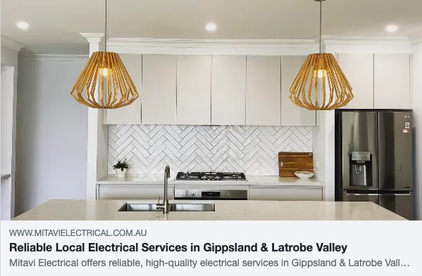 Modern kitchen with pendant lights and appliances.