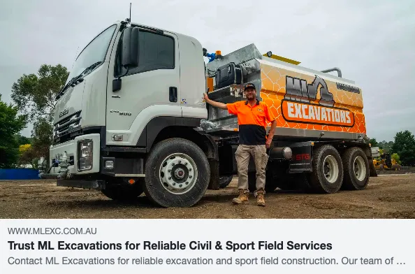 Excavation truck with company logo and worker.